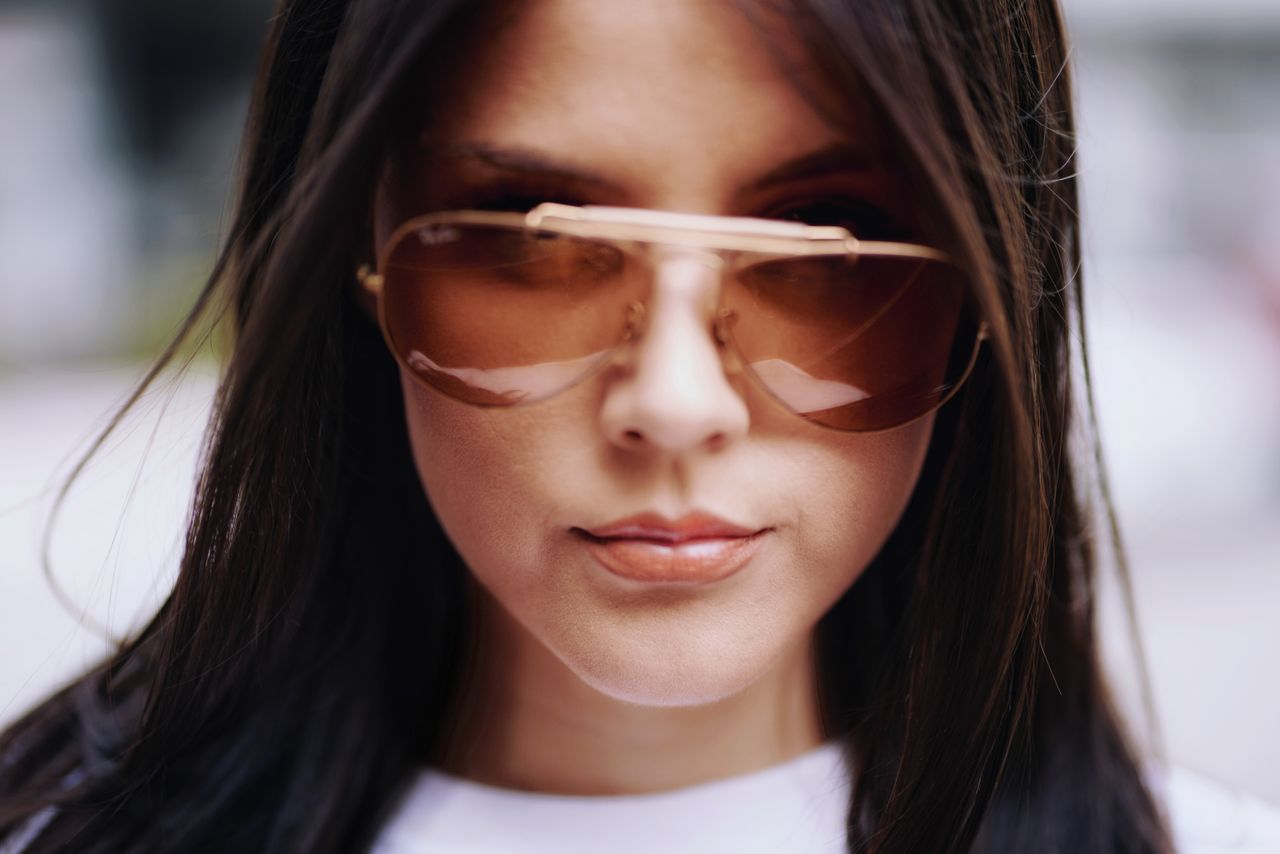 about-us-01 Close-up portrait of a woman in sunglasses featuring stylish fashion and elegance. Perfect for editorial use.